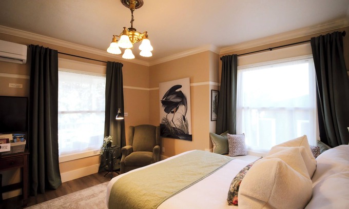 Historic Downtown District Apartment | Relax in the luxurious 1-bedroom Louisa Suite at RedTail Inn. Enjoy a double rain shower, plush linens, and a shared hot tub. Located near downtown Ashland, with off-street parking and high-speed WiFi.