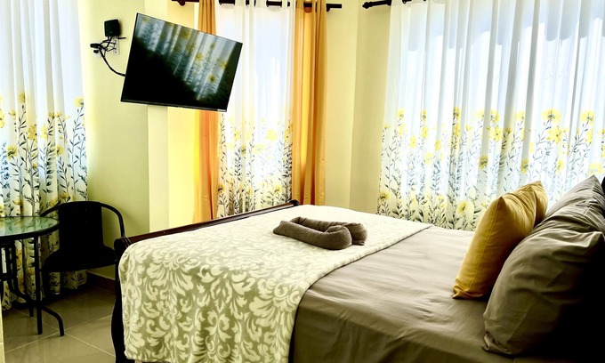 Higuey Hotel | Romantic Hispanic 304 private room with refrigerator and dining area.