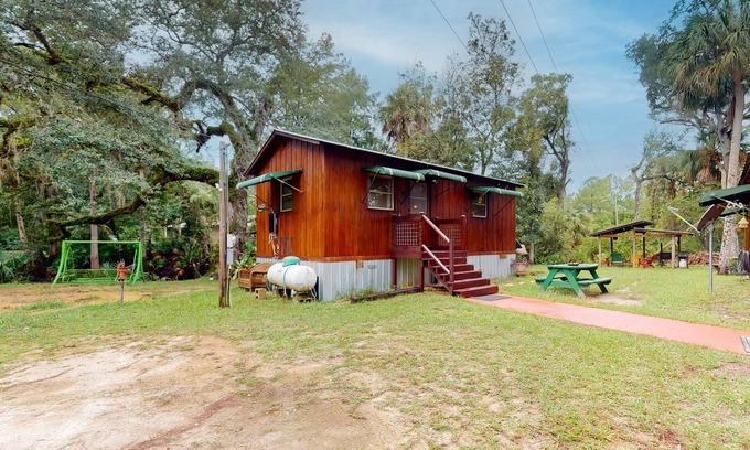 Bronson Cabin | Rustic riverfront cabin with views, firepit, grill, canoe, kitchen, & W/D