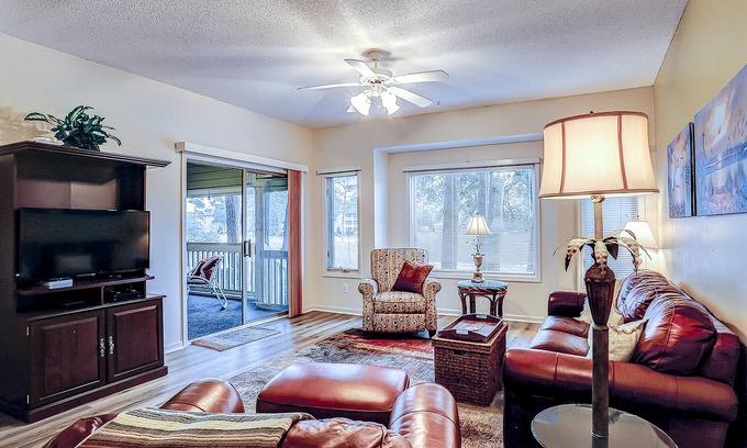 North Myrtle Beach Condo | Secluded golf course front condo with porch, pool, tennis, hot tub, gym, & AC