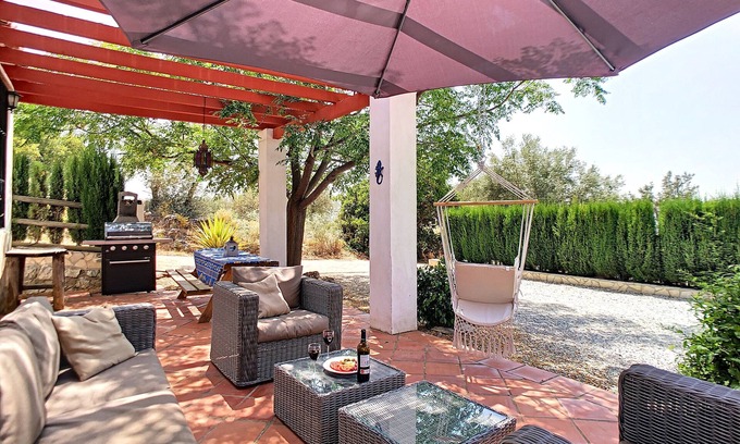 Canillas de Aceituno Villa | Spacious vacation home, adjacent to natural park, with shared pool.