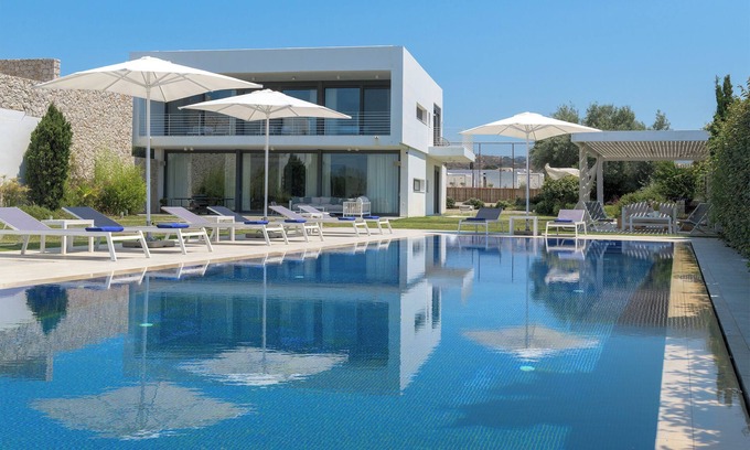 Soroni Villa | Stunning beachfront retreat, private tennis court & infinity pool