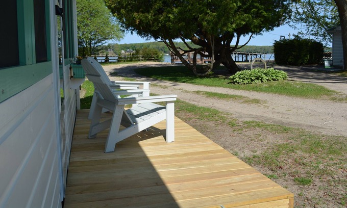 Ludington Cottage | Swan on the Lake with Kayaks, lake frontage, fire pit and screened in porch