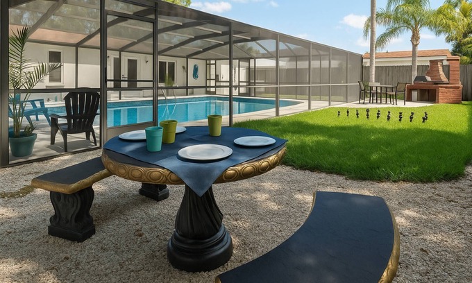 Hyde Park House | Tranquil Times | Serene 3BR Close to RJ Stadium | Screened Heated Pool | Patio Lounge area |Yard Che