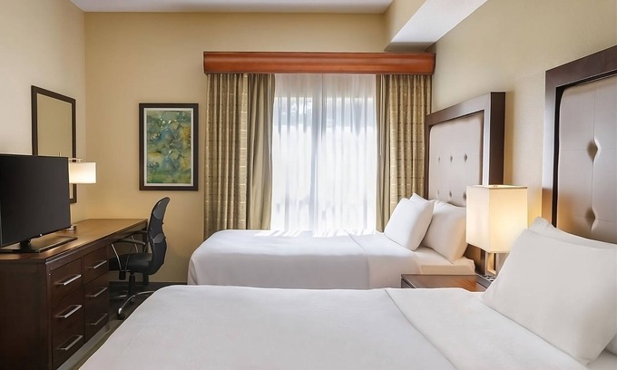 Feather Sound Hotel | Unwind and Indulge In Our Oasis! Outdoor Pool, Free Breakfast, Full Kitchen!