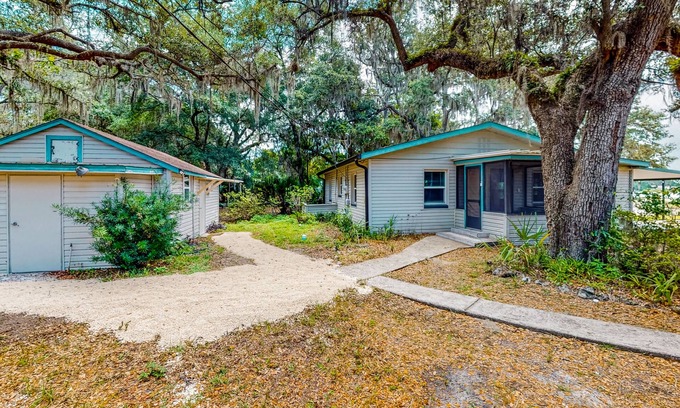 Candler House | Waterfront stay with a dock, firepit, grill, sunroom, separate studio, W/D, & AC