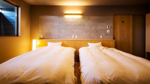 Modern Twin Room with Tatami Area and Semi Open-Air Bath