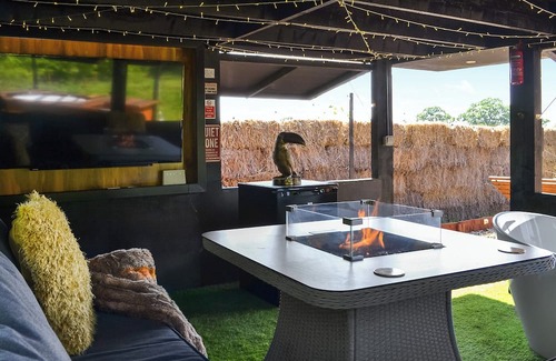 Storwood Cottage | We just love the outside entertainment area with a bath for two, table top fire pit and large Smart