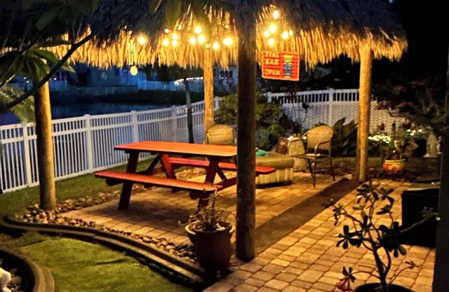 Beautiful lakefront retreat with outdoor kitchen, tiki hut and spa.