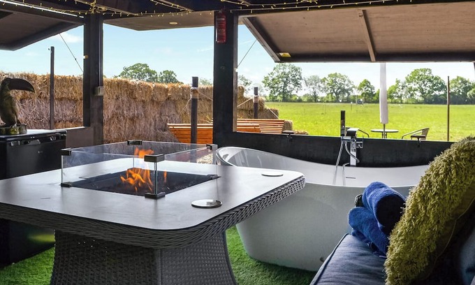 Storwood Cottage | We just love the outside entertainment area with a bath for two, table top fire pit and large Smart